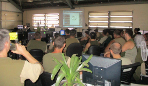 Prison classroom with teacher demonstrating use of software program to prison inmates.